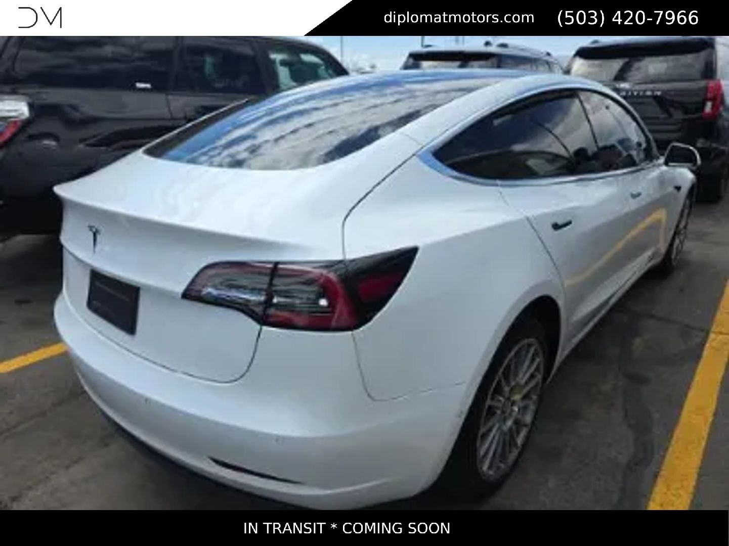A white Tesla Model 3 photographed on the Diplomat lot