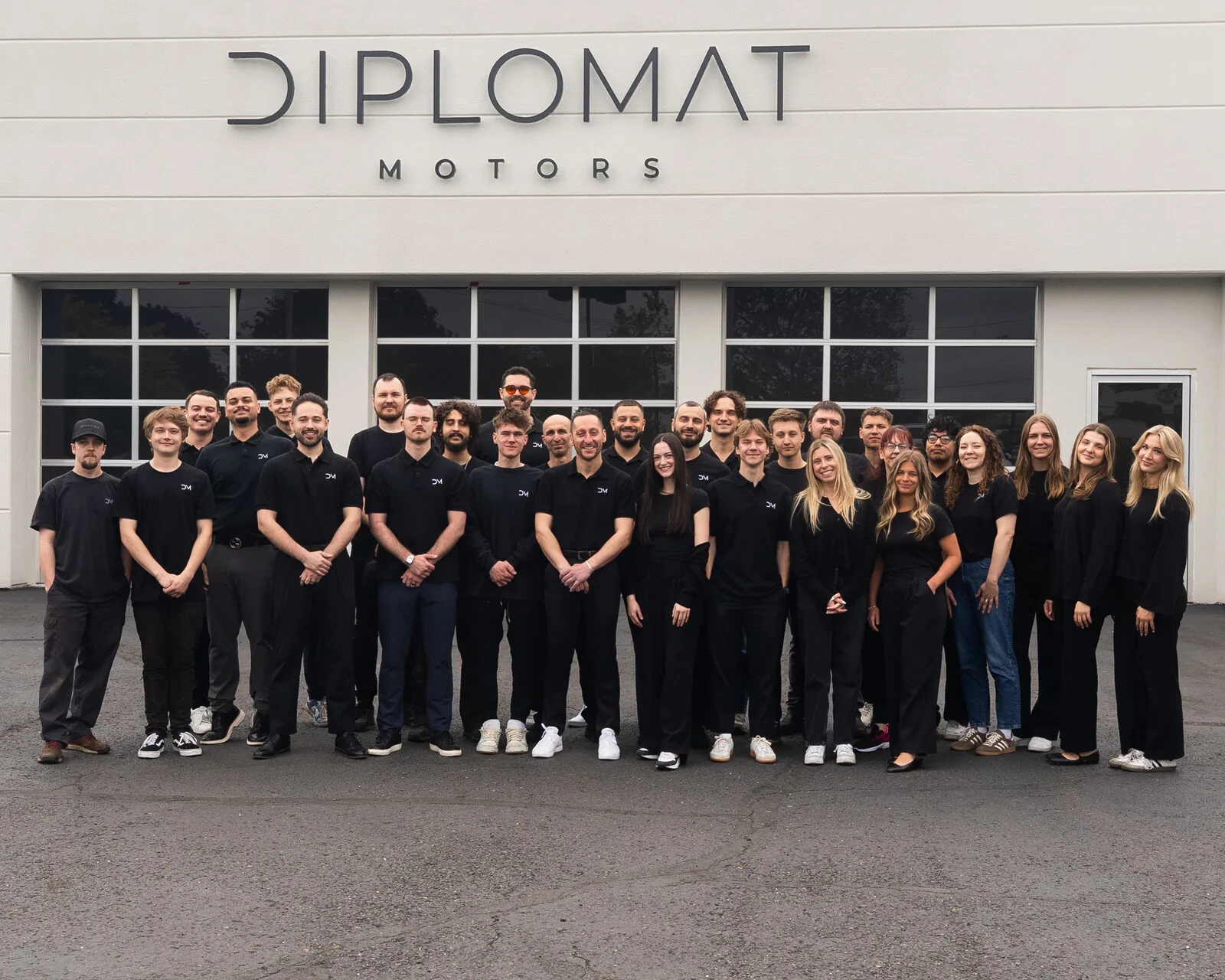 The full Diplomat Motors team in front of the dealership